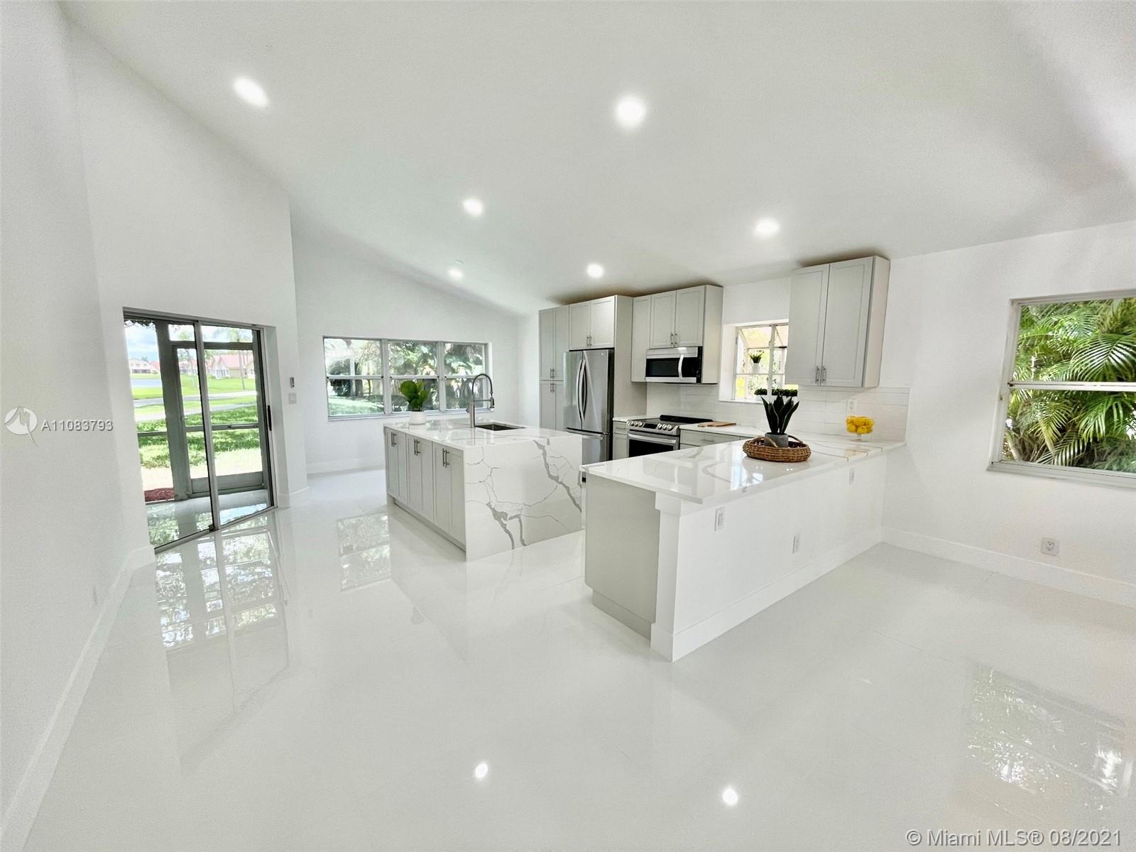 11069 Rios Road, Unit 11069 Boca Raton, FL 33498 - Photo 3 of 14 a large white kitchen with lots of counter space