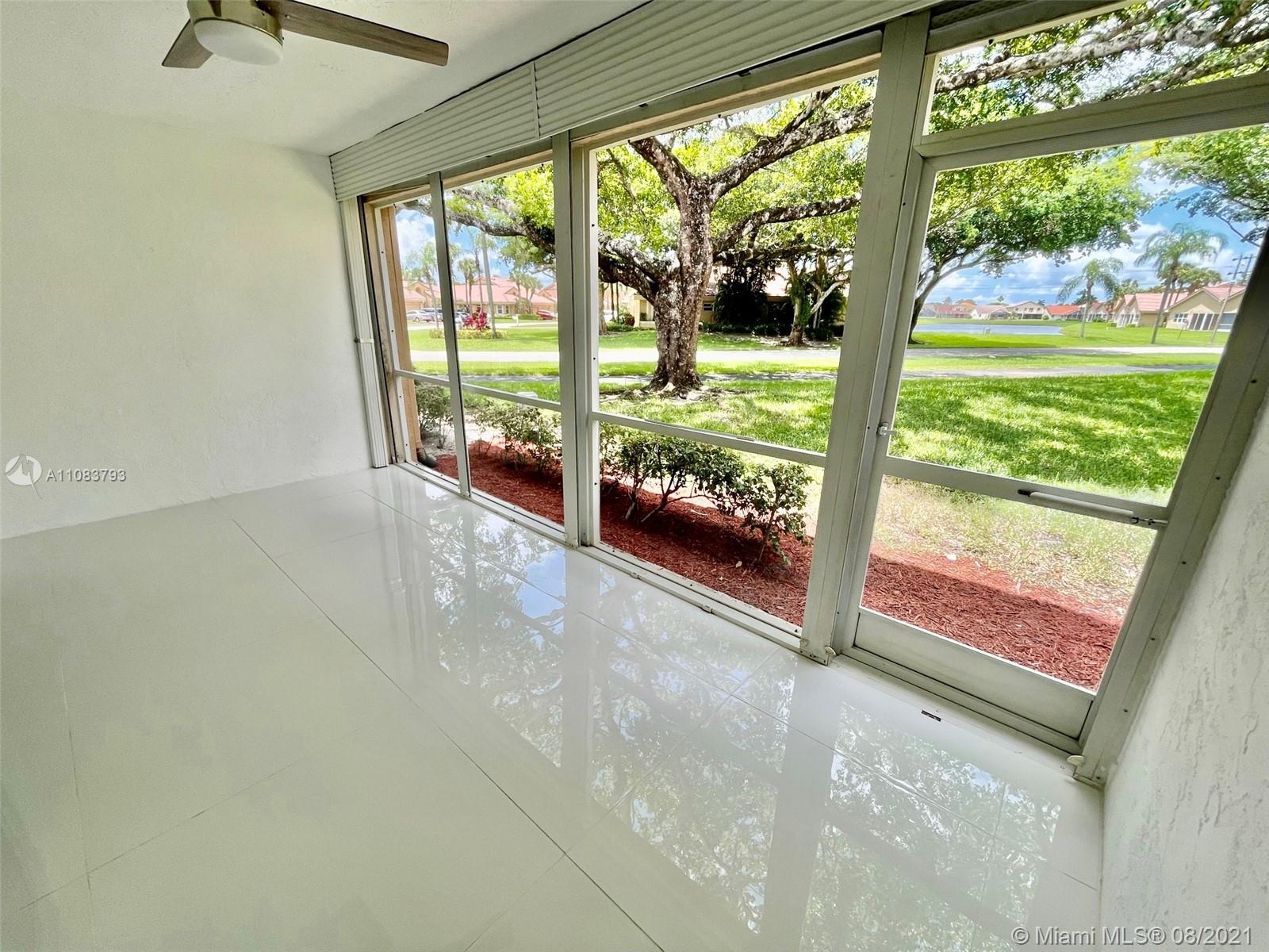 11069 Rios Road, Unit 11069 Boca Raton, FL 33498 - Photo 6 of 14 a view of an empty room with a large window
