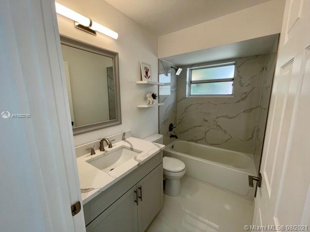 11069 Rios Road, Unit 11069 Boca Raton, FL 33498 - Photo 7 of 14 a bathroom with a sink a toilet and shower