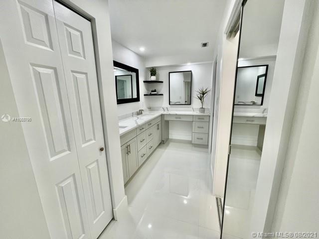 11069 Rios Road, Unit 11069 Boca Raton, FL 33498 - Photo 10 of 14 a bathroom with a sink a mirror and a vanity