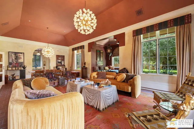 a dining room with furniture a chandelier and wooden floor