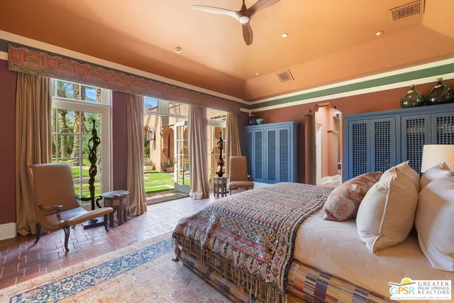 a bedroom with a bed next to a window