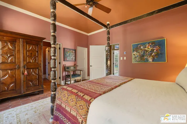 a bedroom with furniture and a large window