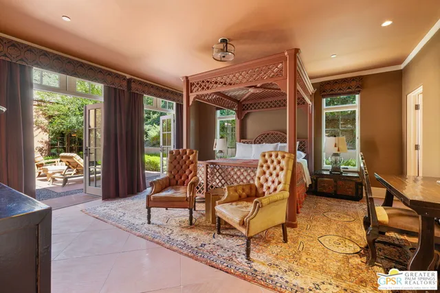 a view of a patio with couches table and chairs and potted plants