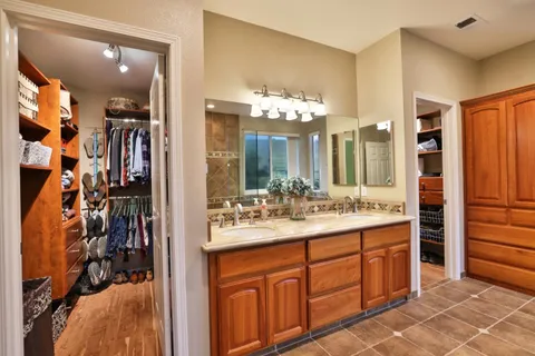 a bathroom with a sink vanity and a mirror
