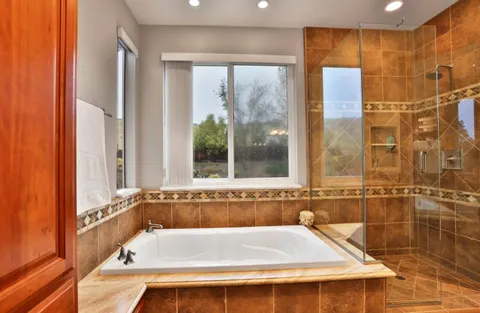 a bathroom with a bath tub and shower