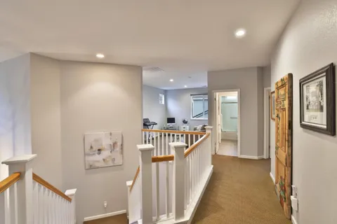 a view of a hallway to a livingroom with furniture
