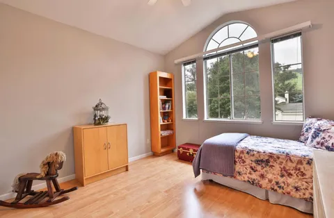 a bedroom with a bed and a window