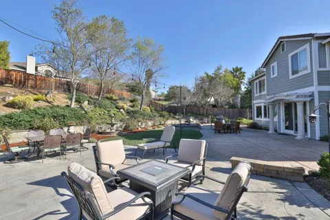 a view of a patio with a table and chairs