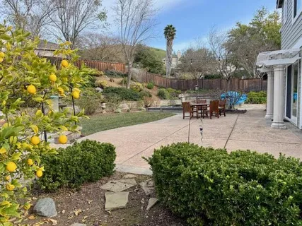 a view of a backyard with table and chairs and a fire pit
