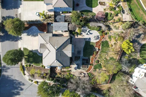 a aerial view of a house with a yard and garden