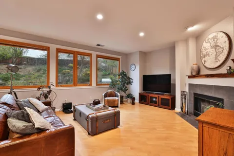 a living room with furniture a flat screen tv and a fireplace