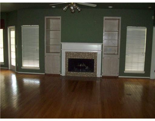 7677 Dallas Street Corpus Christi, TX 78413 - Photo 2 of 9 a view of an empty room with wooden floor and a fireplace