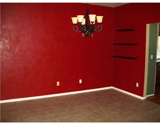 a view of a room with a chandelier fan