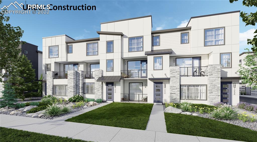 a front view of a residential apartment building with a yard