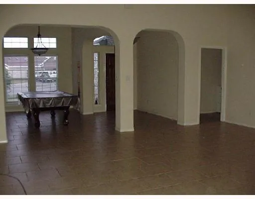 a view of a livingroom with furniture wooden floor and a floor to ceiling window