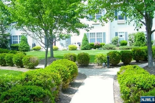 a view of backyard of house with green space