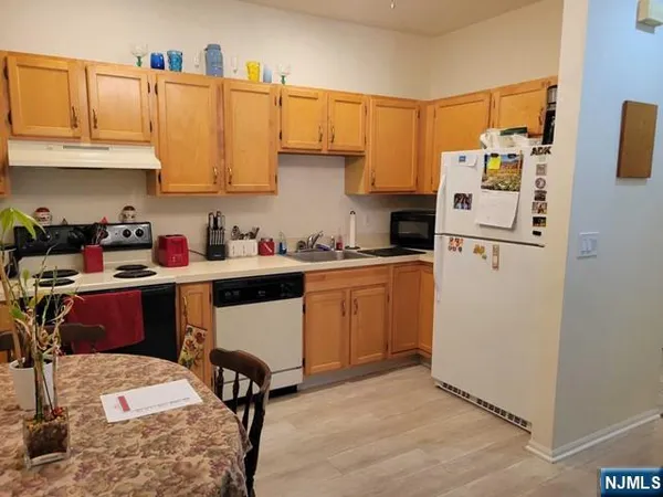 a kitchen with a sink appliances and cabinets