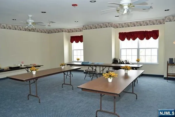 a room with pool table and windows