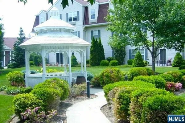 a view of a house with sitting area and garden