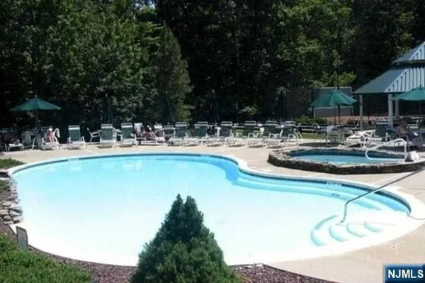 a view of a house with swimming pool and sitting area