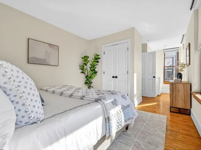 a bedroom with a large bed and a couch