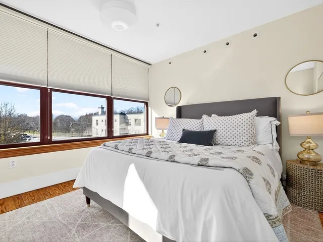 a bed sitting in a bedroom next to a window