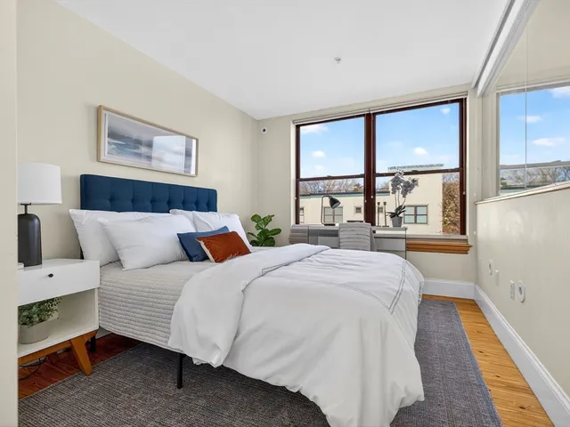 a bedroom with a large bed and a large window