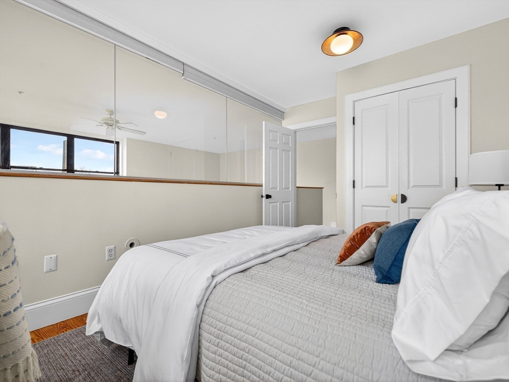 62-76 Cornwall Street, Unit 74 (E) Boston, MA 02130 - Photo 23 of 34 a bed room with a bed and a window