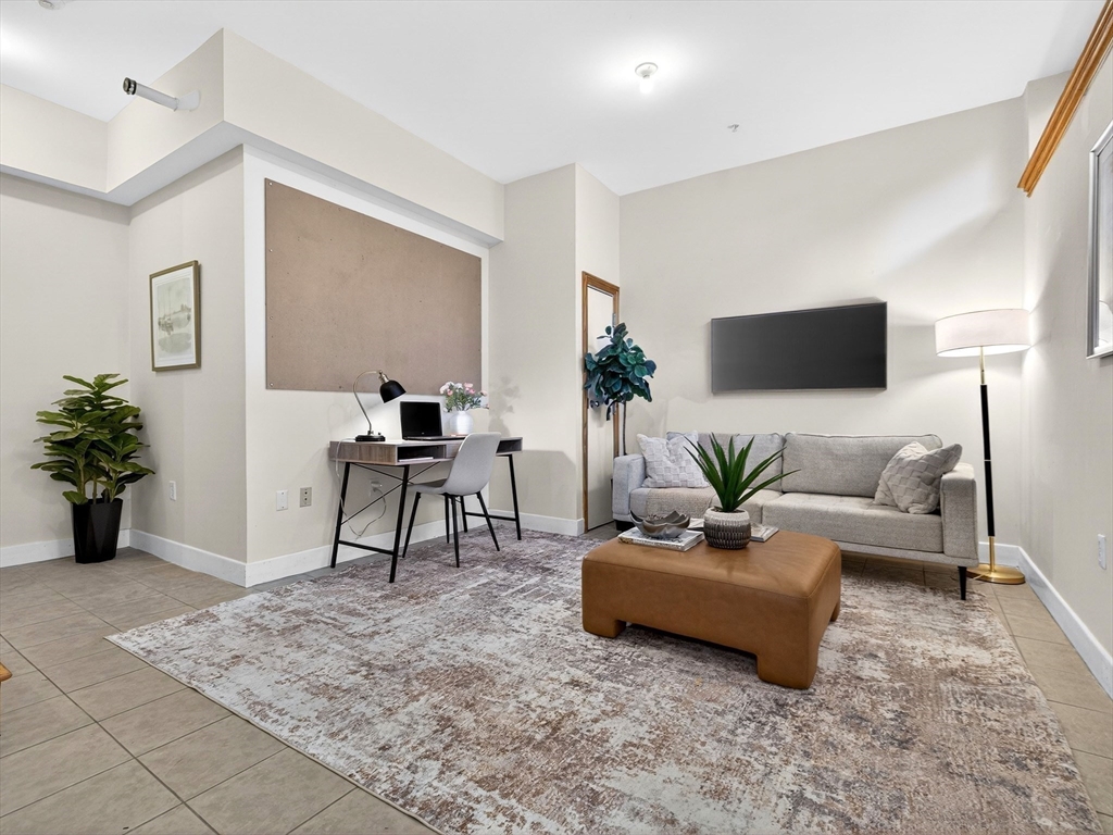 62-76 Cornwall Street, Unit 74 (E) Boston, MA 02130 - Photo 25 of 34 a living room with furniture and a potted plant