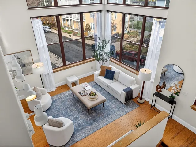a living room with furniture and a floor to ceiling window