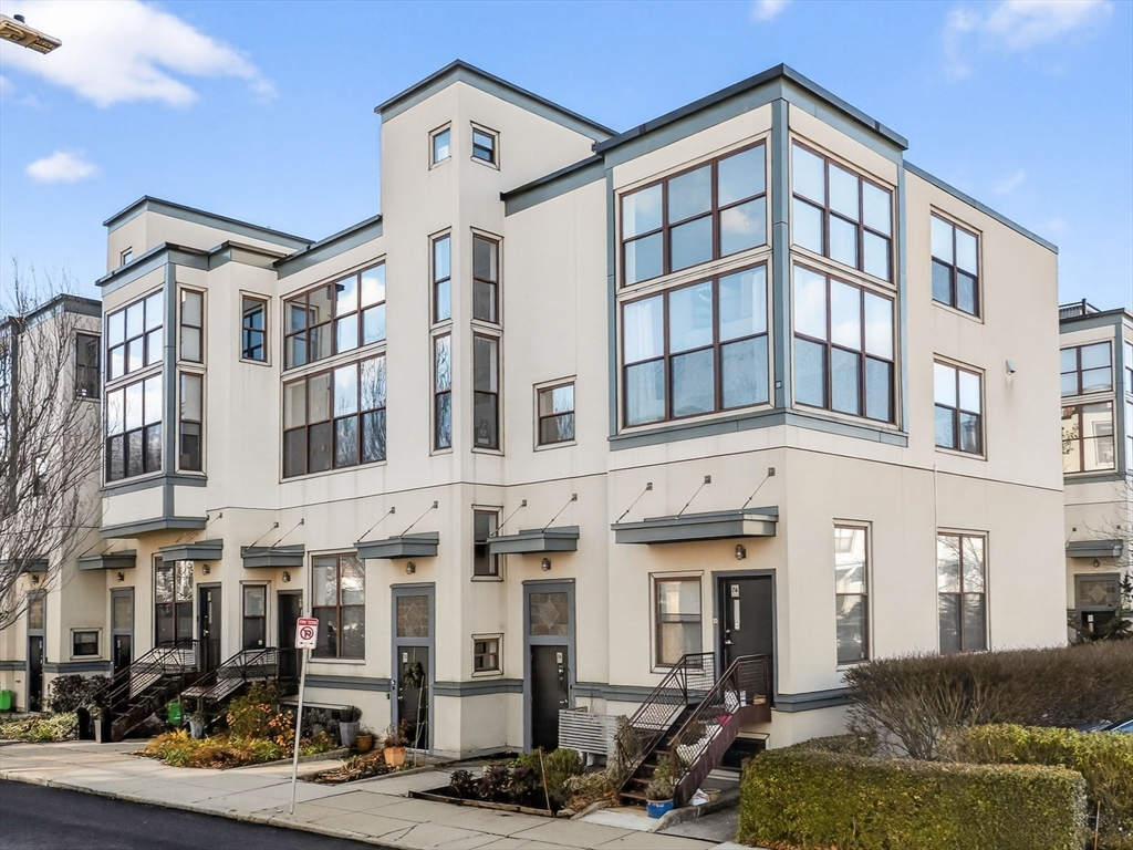 62-76 Cornwall Street, Unit 74 (E) Boston, MA 02130 - Photo 4 of 34 a front view of a building with glass windows