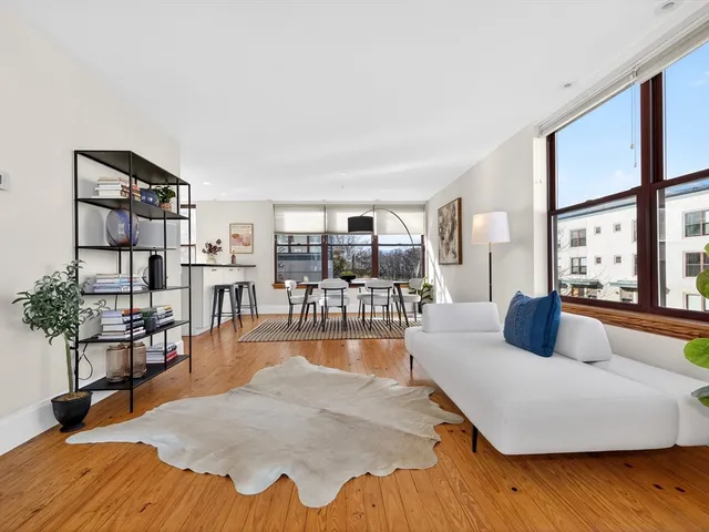 a bedroom with furniture and a wooden floor