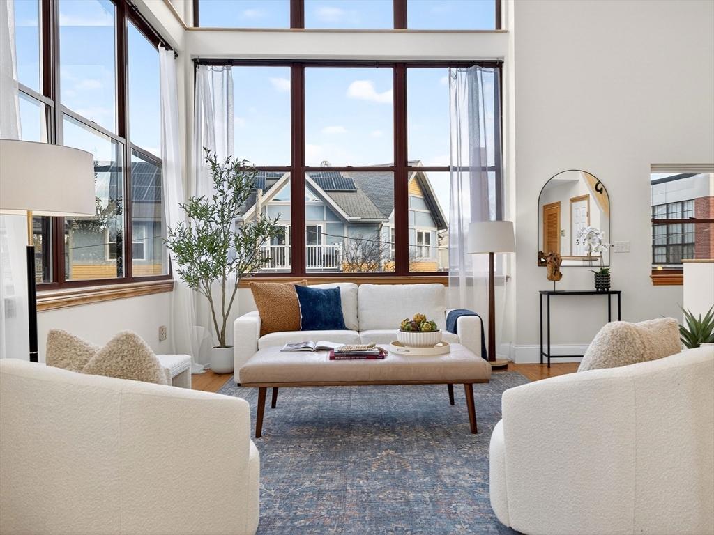 62-76 Cornwall Street, Unit 74 (E) Boston, MA 02130 - Photo 6 of 34 a living room with furniture and a large window