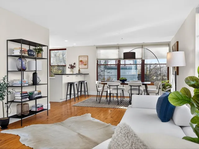 a living room with furniture and a floor to ceiling window