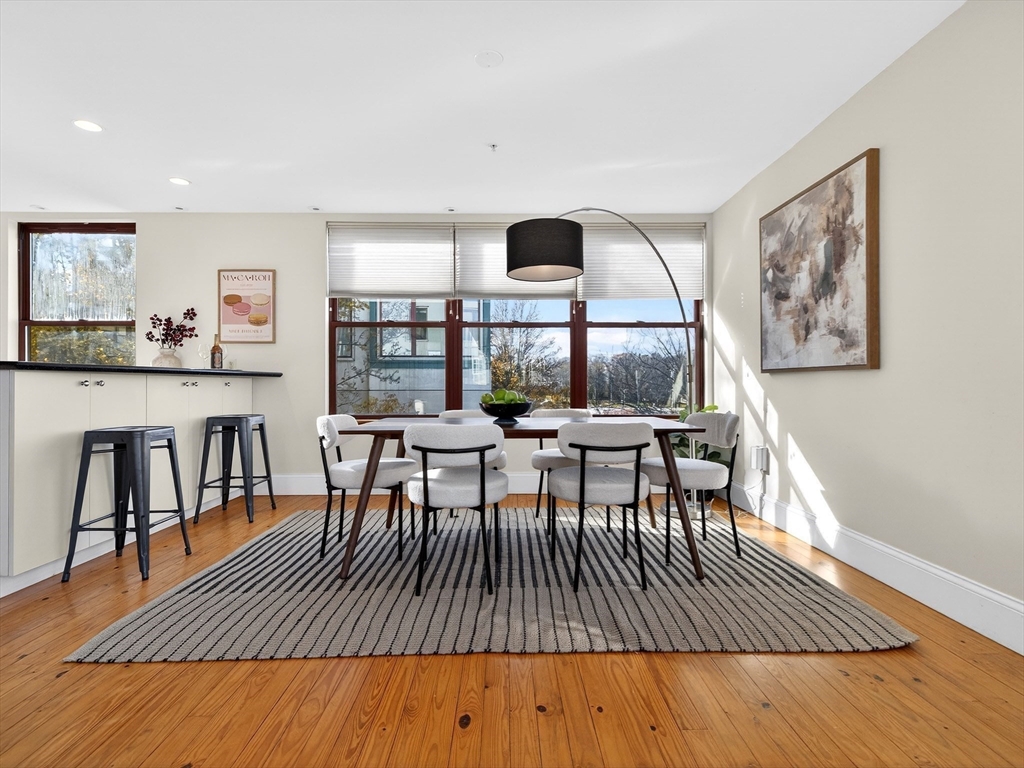 62-76 Cornwall Street, Unit 74 (E) Boston, MA 02130 - Photo 8 of 34 a view of a dining room with furniture and wooden floor