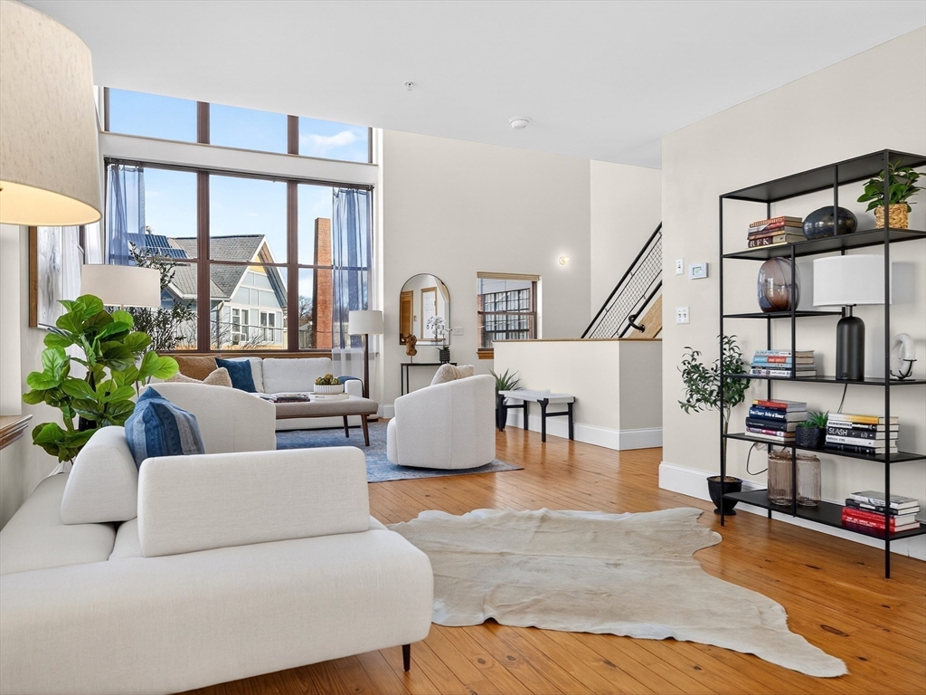 62-76 Cornwall Street, Unit 74 (E) Boston, MA 02130 - Photo 9 of 34 a living room with furniture and a floor to ceiling window