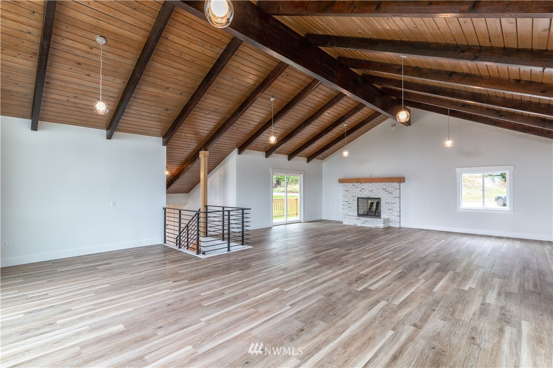 33114 Sultan Basin Road Sultan, WA 98294 - Photo 13 of 30 a view of an empty room with wooden floor and a window