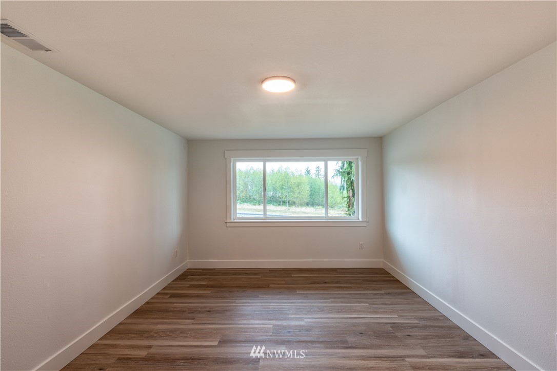 33114 Sultan Basin Road Sultan, WA 98294 - Photo 17 of 30 an empty room with wooden floor and windows