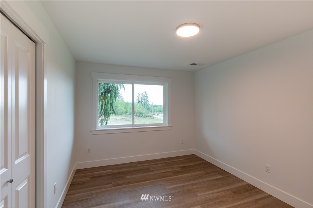 33114 Sultan Basin Road Sultan, WA 98294 - Photo 20 of 30 an empty room with wooden floor and windows