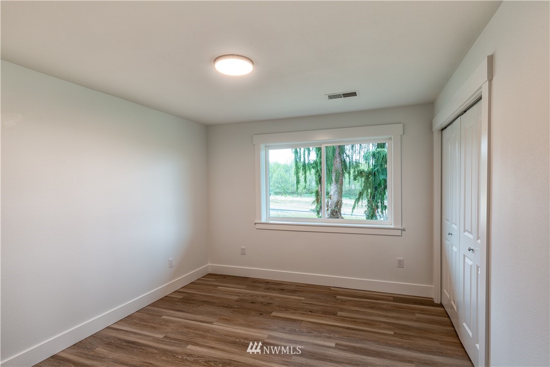 33114 Sultan Basin Road Sultan, WA 98294 - Photo 21 of 30 a view of an empty room with wooden floor and a window
