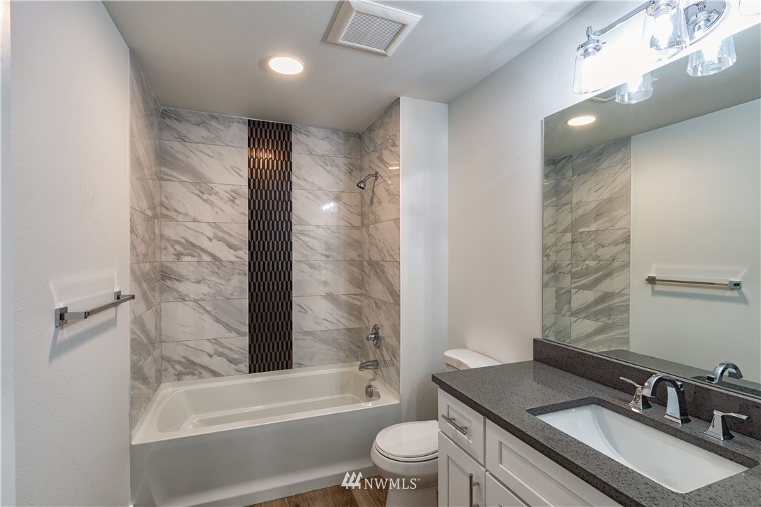 33114 Sultan Basin Road Sultan, WA 98294 - Photo 24 of 30 a bathroom with a bathtub shower sink vanity mirror and toilet
