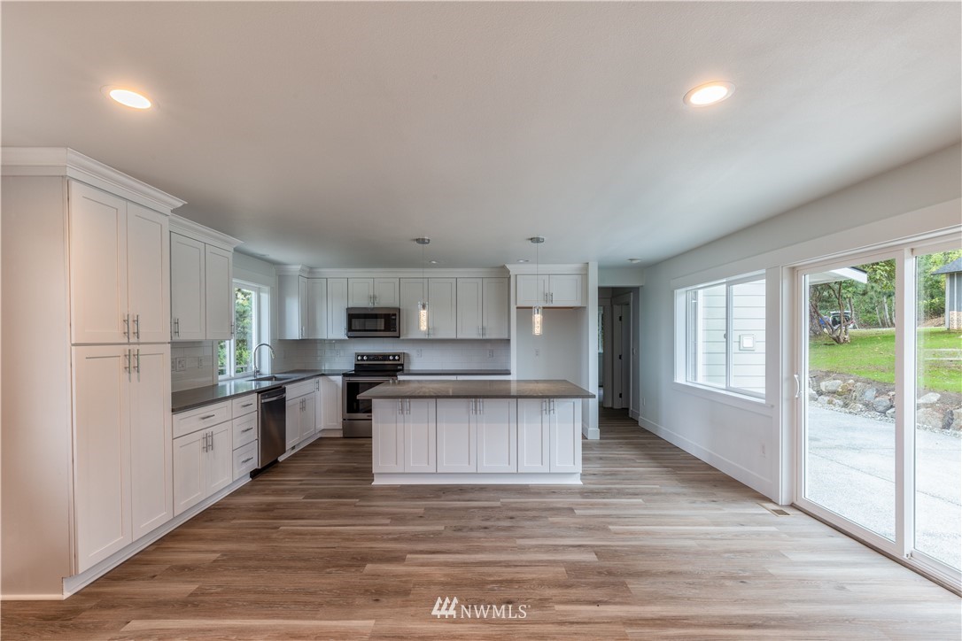 33114 Sultan Basin Road Sultan, WA 98294 - Photo 6 of 30 a kitchen with stainless steel appliances granite countertop a refrigerator sink and stove