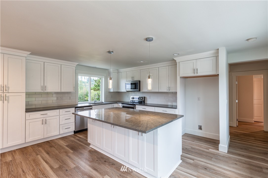 33114 Sultan Basin Road Sultan, WA 98294 - Photo 7 of 30 a kitchen with stainless steel appliances granite countertop a sink and cabinets