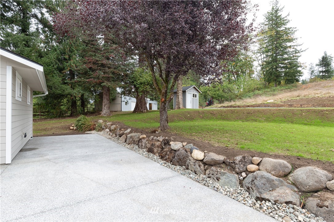 33114 Sultan Basin Road Sultan, WA 98294 - Photo 8 of 30 a view of a house with a yard and a garden