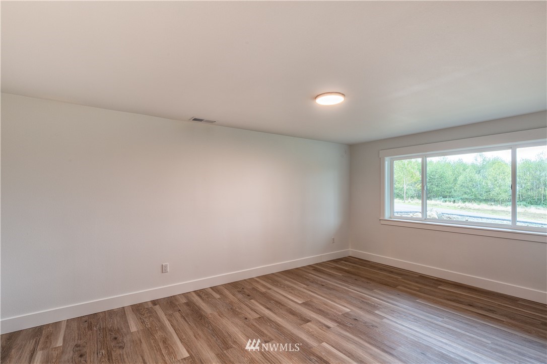 33114 Sultan Basin Road Sultan, WA 98294 - Photo 10 of 30 an empty room with wooden floor and windows