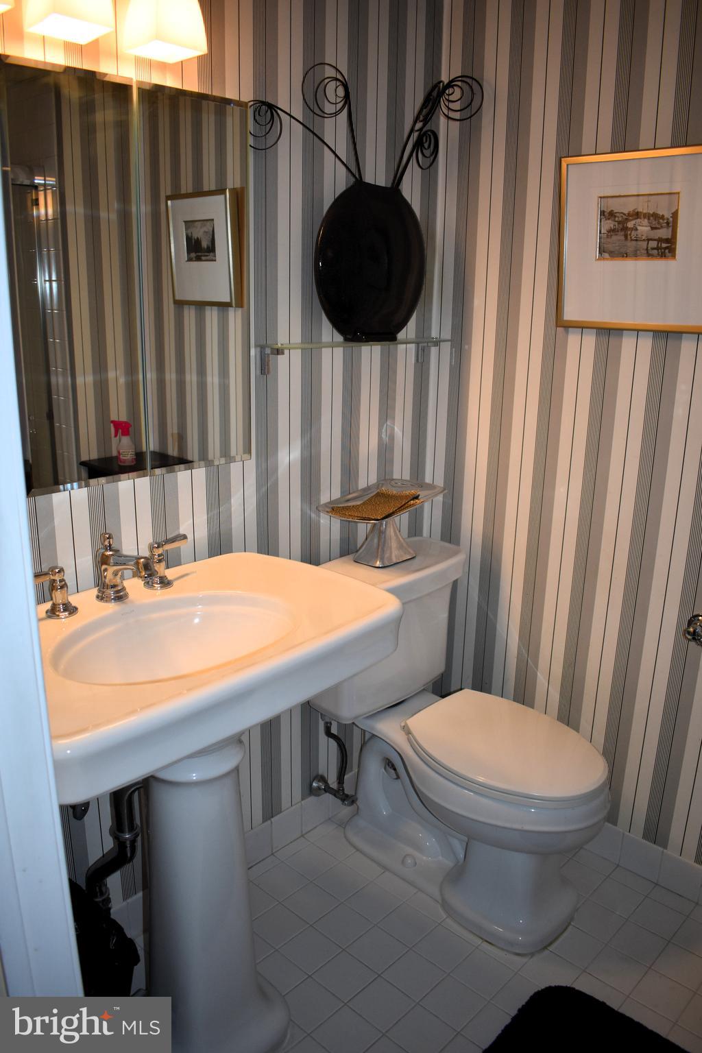 3409 Centennial Station Warminster, PA 18974 - Photo 32 of 76 a bathroom with a toilet a sink and a mirror