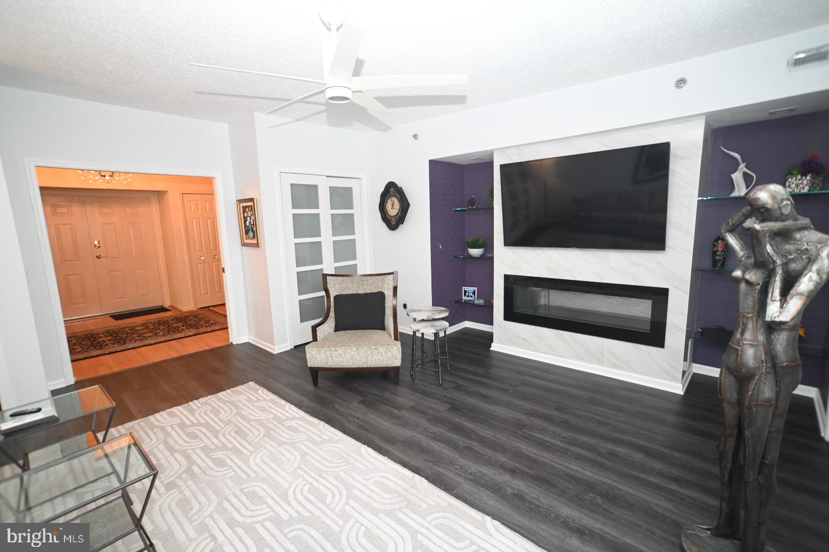 3409 Centennial Station Warminster, PA 18974 - Photo 37 of 76 a living room with furniture a flat screen tv and a fireplace