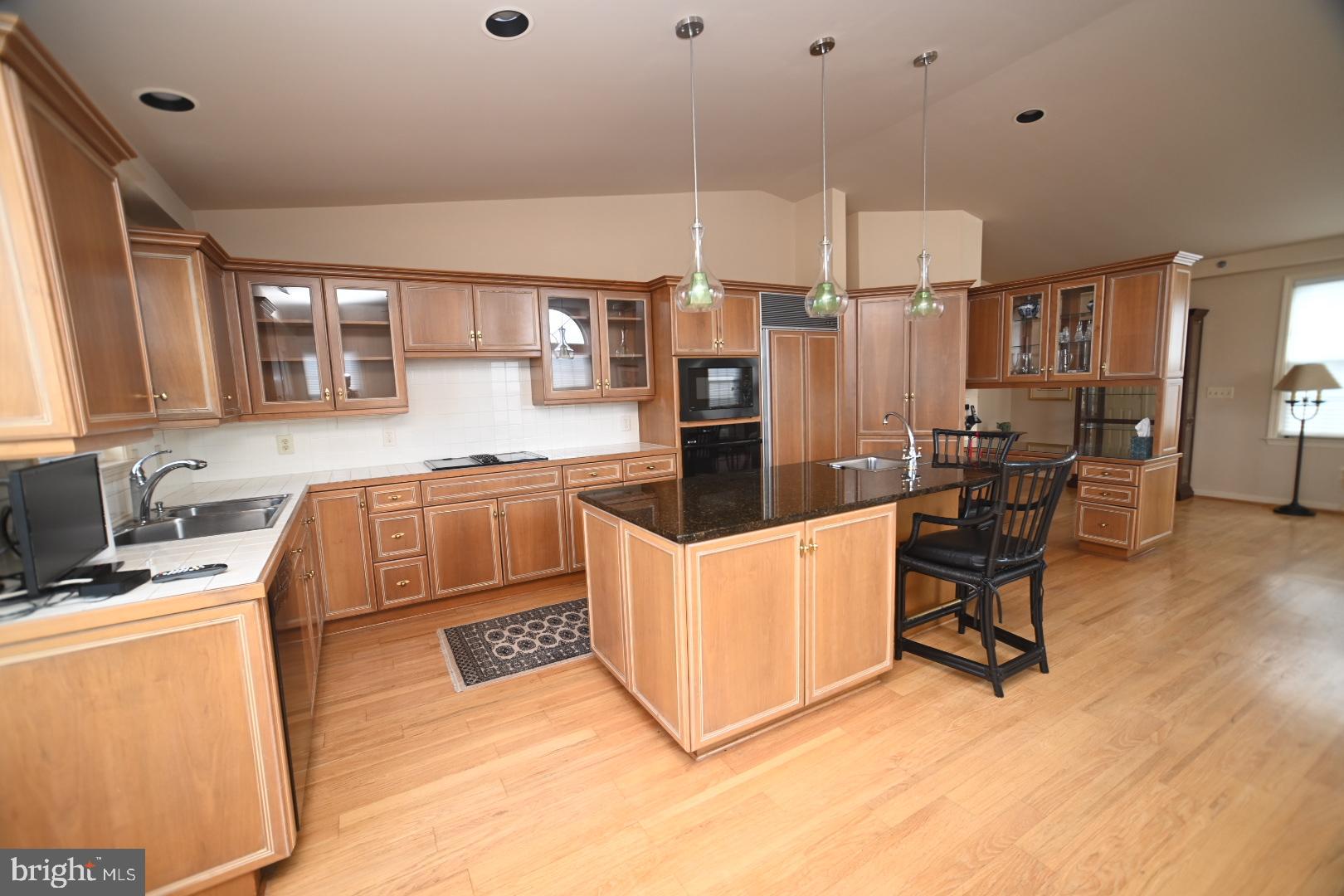 3409 Centennial Station Warminster, PA 18974 - Photo 8 of 76 a kitchen with stainless steel appliances kitchen island granite countertop a stove a sink and a refrigerator