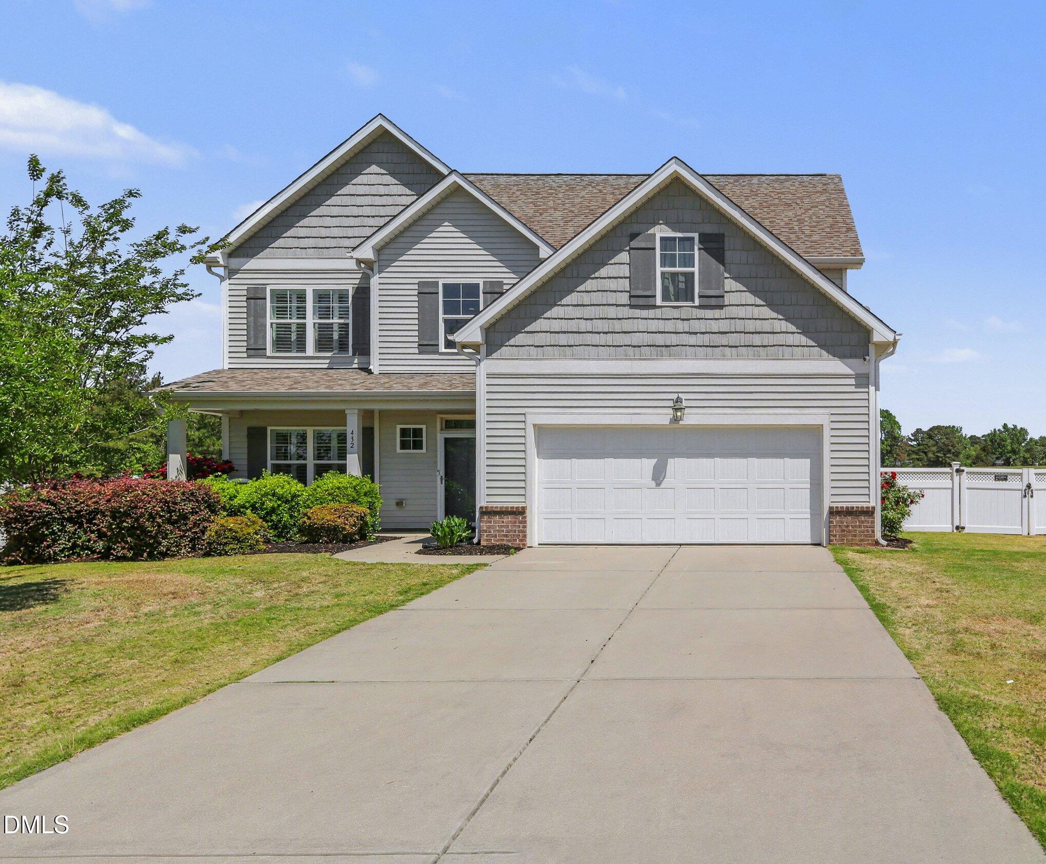 432 Seabring Lane Raleigh, NC 27603 - Photo 1 of 29 a front view of a house with a yard and garage